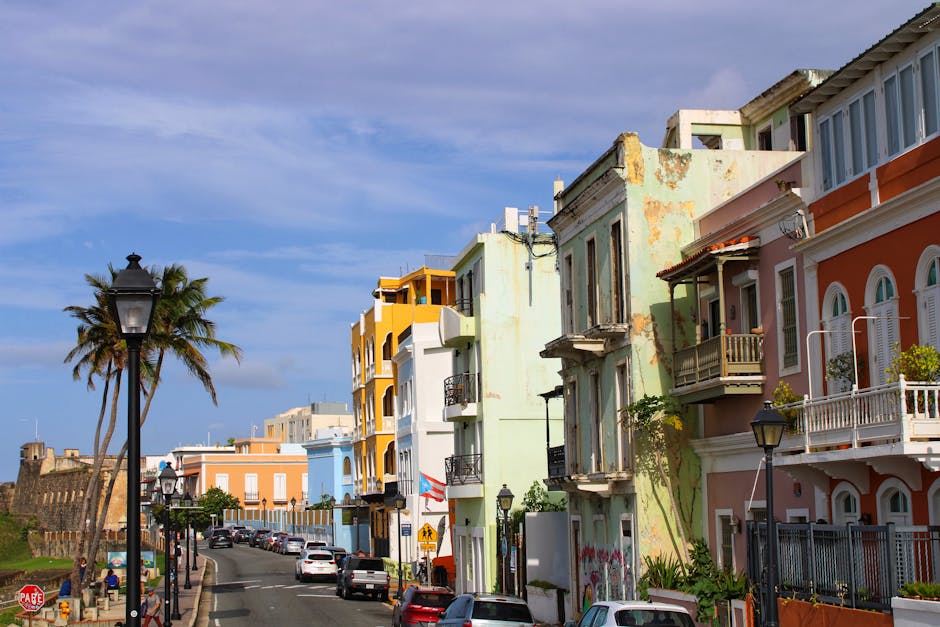 Vibrant colonial buildings line a sunny street in Old San Juan, Puerto Rico's historic district.