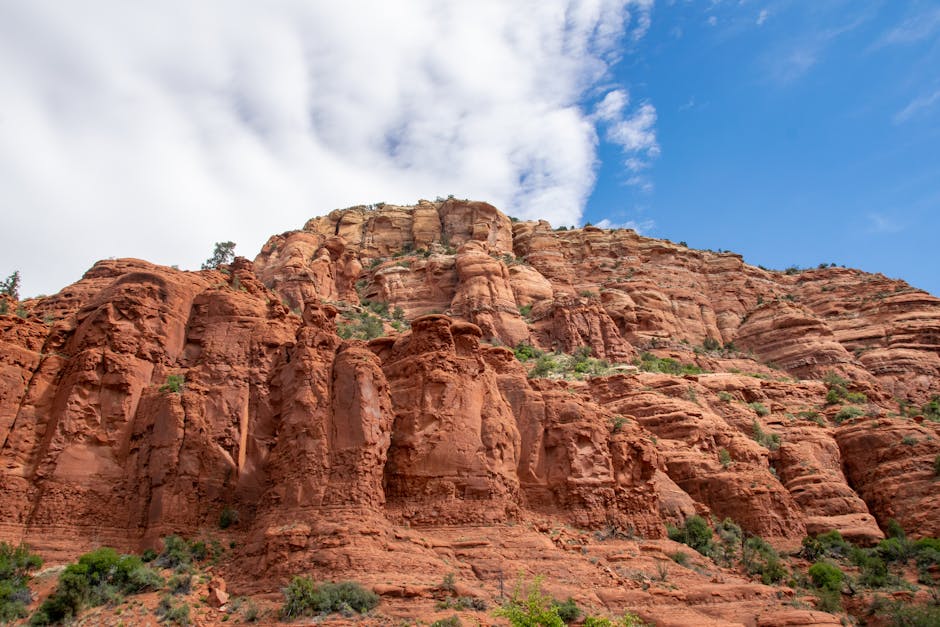 Beautiful red rock formations under a bright sky in Sedona, Arizona, showcasing natural erosion.