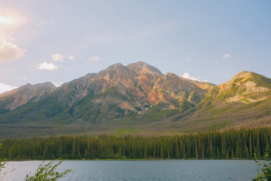 Stunning view of mountains and lake in Banff, Alberta, under a clear blue sky.