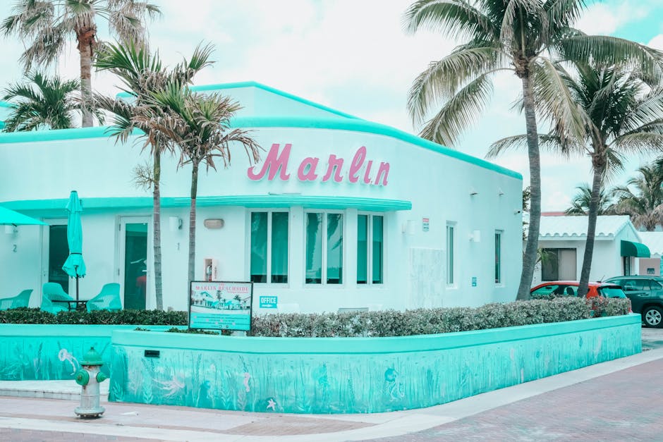 Explore the vibrant Art Deco architecture of Marlin Hotel in Hollywood, FL, with palm trees and a pastel palette.