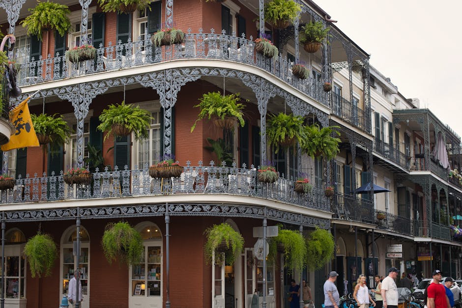 Beautiful wrought iron balconies and lush greenery in New Orleans' French Quarter.