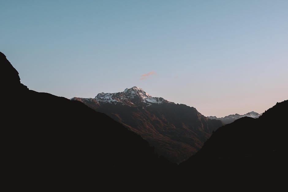 Tranquil view of the Southern Alps in New Zealand at dusk, capturing serene mountain landscapes.