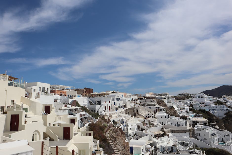 Beautiful white buildings of Santorini under a clear blue sky.