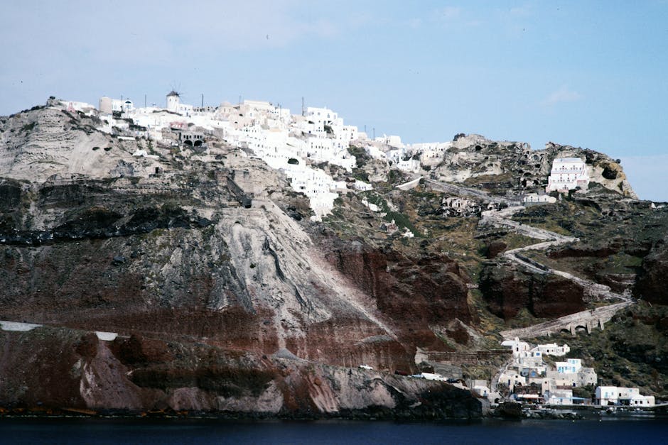 Stunning Santorini cliffside with traditional white buildings overlooking the Aegean Sea.
