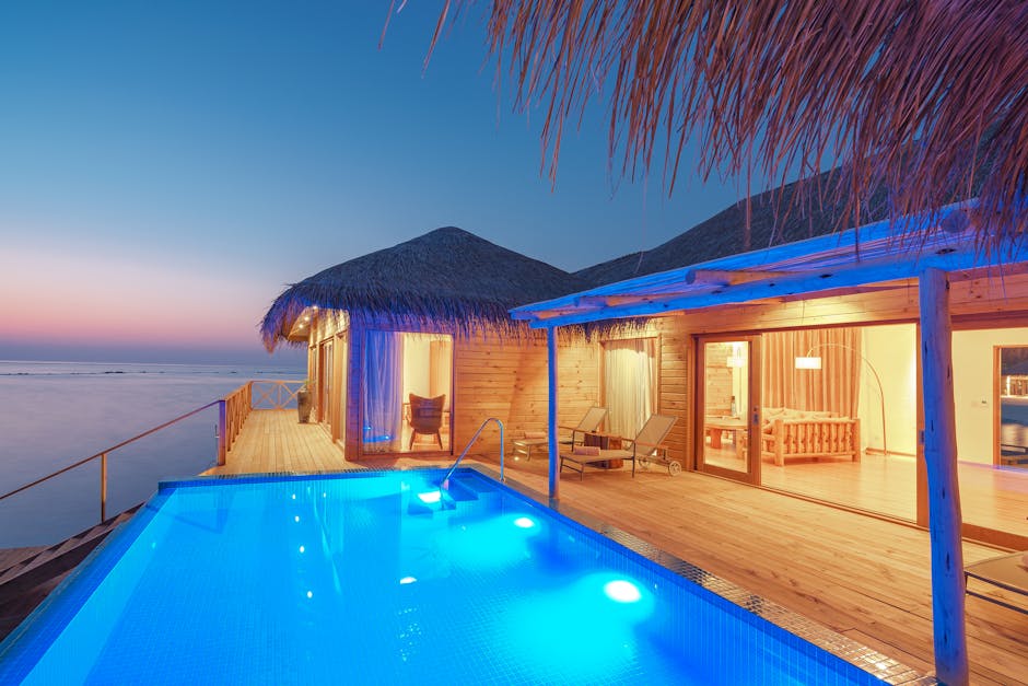 Tranquil overwater bungalow with infinity pool and ocean view at sunset. Perfect tropical paradise getaway.