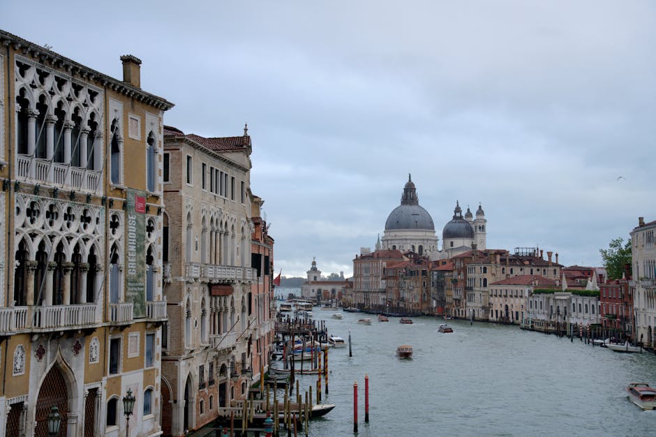 Beautiful view of Venice's Grand Canal with historic architecture on a cloudy day.
