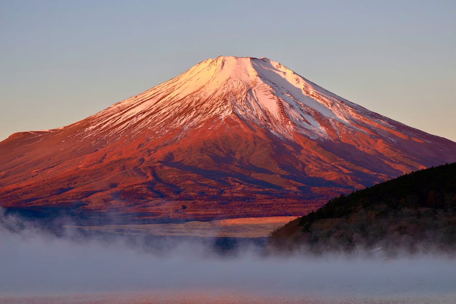 Beautiful sunrise view of Mount Fuji from Fujinomiya, Japan, with mist and snow-capped peak.