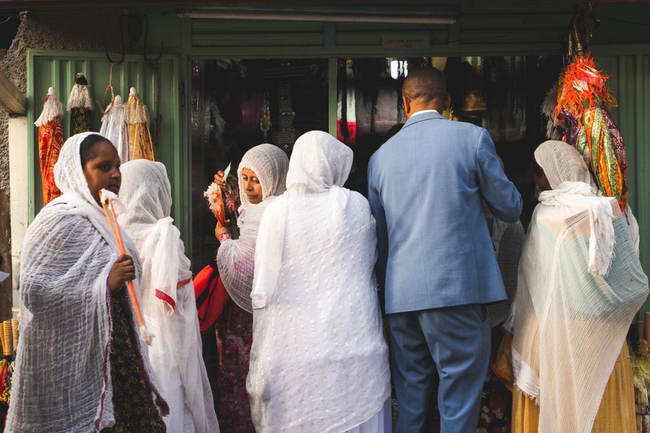 A group of people in traditional attire shopping at a market in Addis Ababa, Ethiopia.