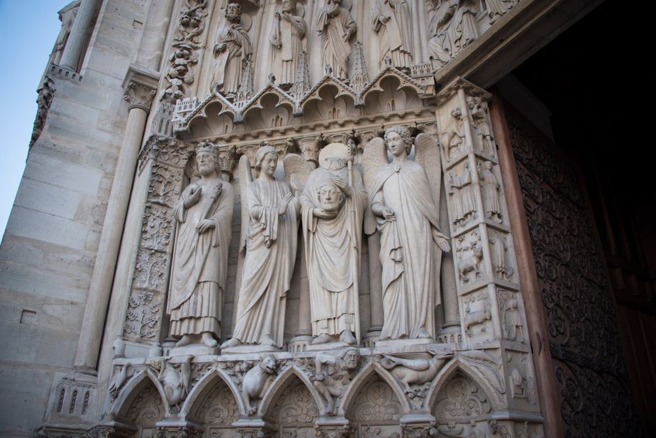 Close-up of detailed Gothic sculptures on a historic church facade showcasing religious art.