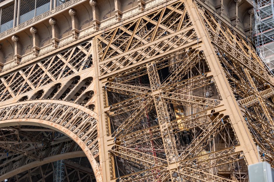 Detailed view of the iron lattice structure of the Eiffel Tower in Paris.