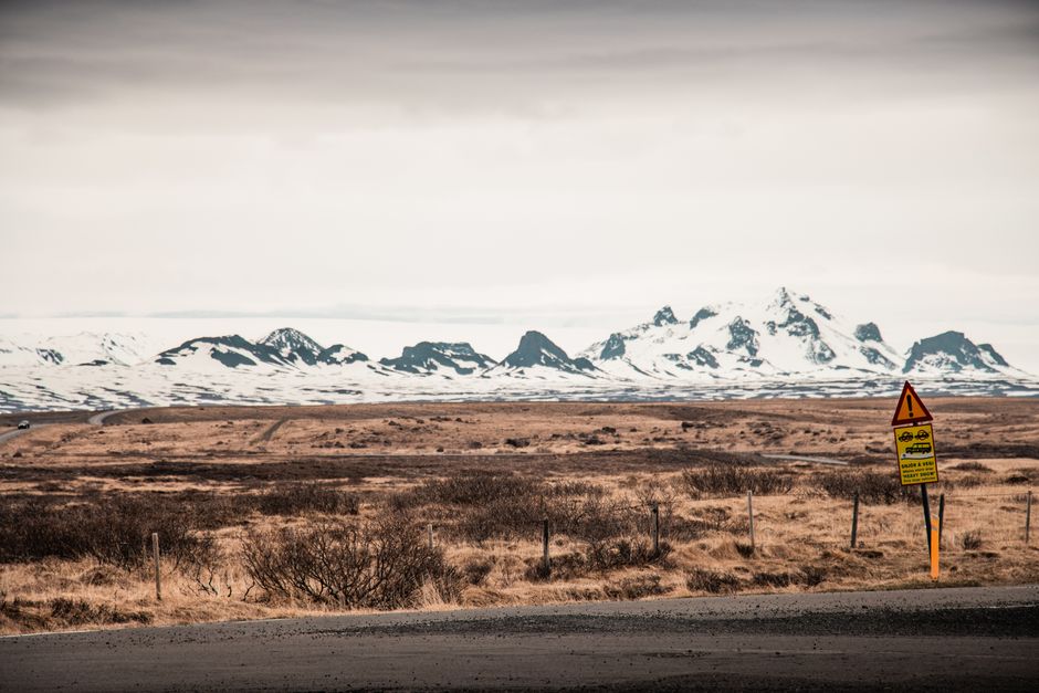 A breathtaking winter landscape showing vast fields and mountains near Reykjavík, Iceland.