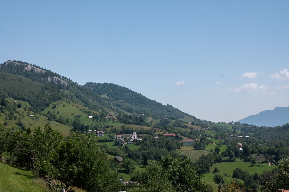 Beautiful summer view of the lush hills and village in Măgura, Brașov, Romania.