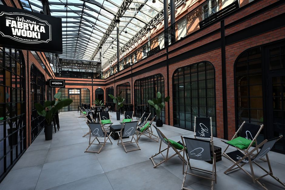 Interior of the Vodka Factory Museum Kraków with seating and glass ceiling.