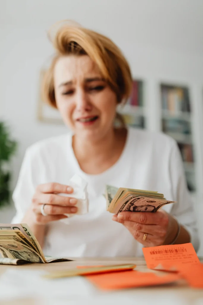 Woman emotionally managing finances, counting money