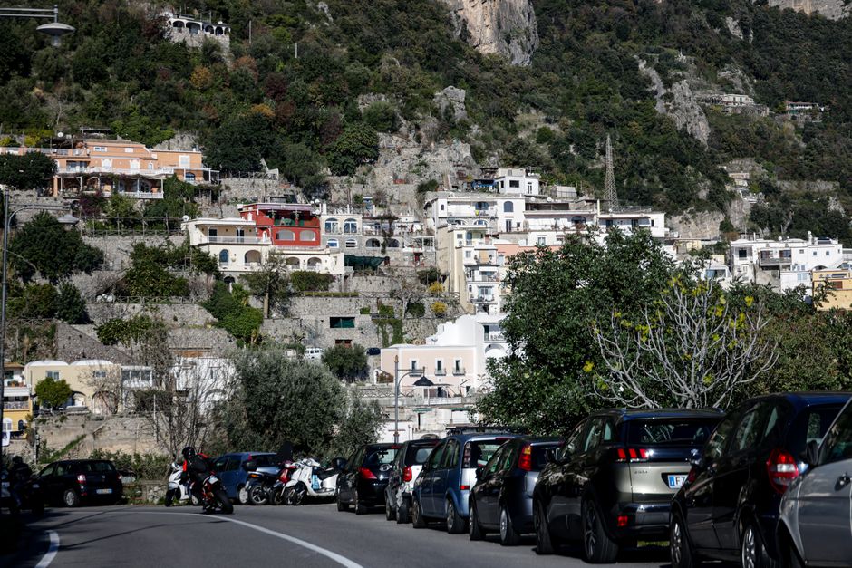 Hillside houses in an Italian village with scenic architecture and greenery.