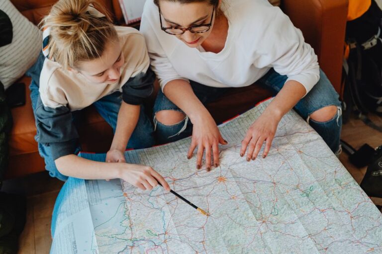 A mother and daughter plan their journey using a map, symbolizing adventure and bonding.